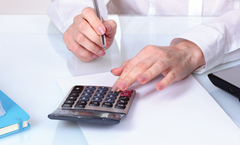 Hands and calculator