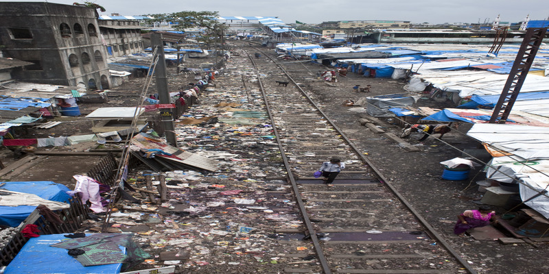 Engineer develops self-propelled track scavenging vehicle 33 Slum beside a railway line in Mumbai
