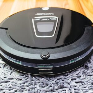 Robotic vacuum cleaner on wood parquet floor, Smart vacuum